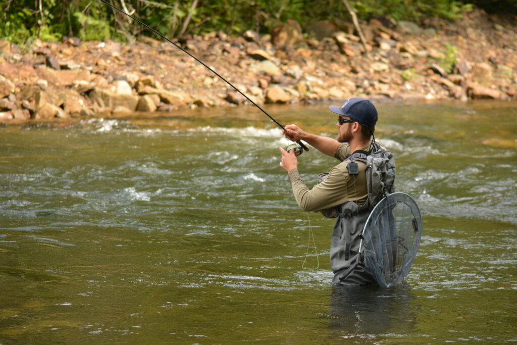 Mike Komara hooked up on a trout in a fly fishing competition