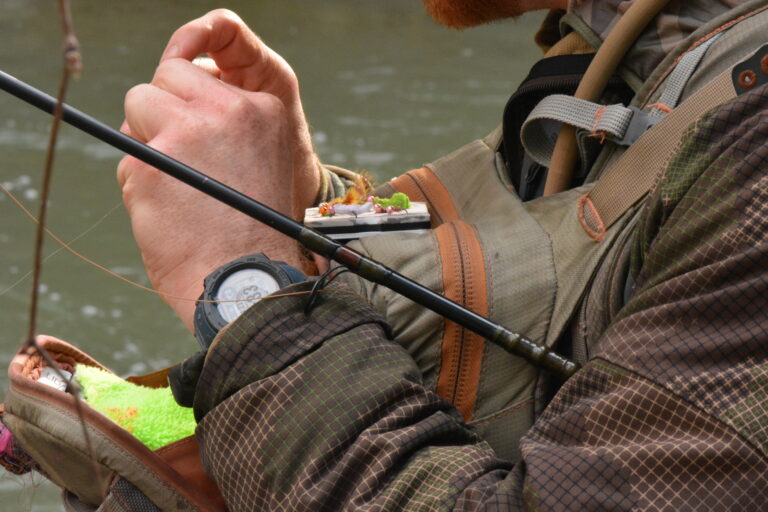 An angler ties on a fly on a central Pennsylvania river