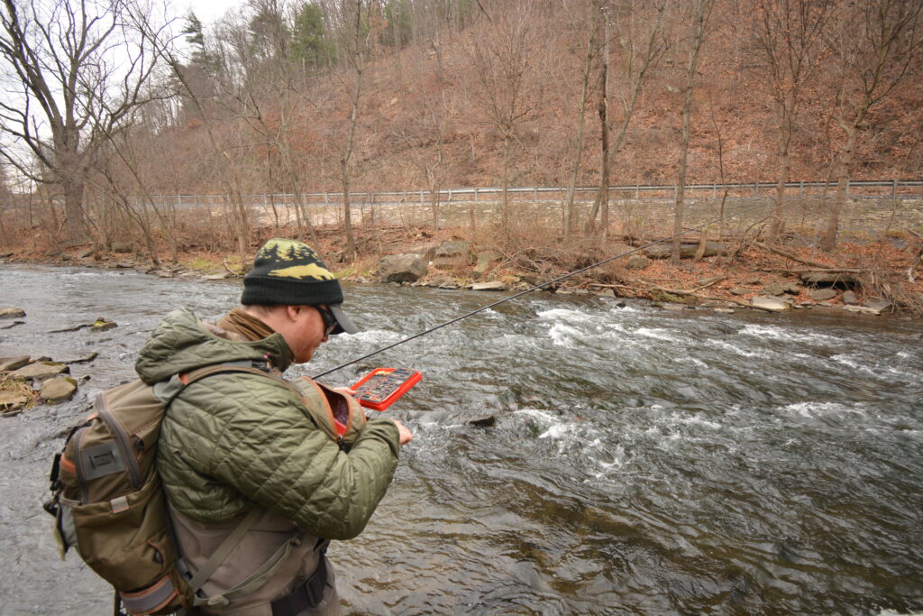 An angler looking at flies on Kish Creek in Pa