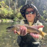 A young angler with a brown trout caught on a guided fly fishing trip in Central Pa