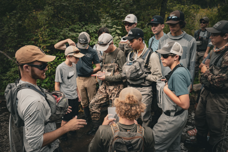 Mike Komara teaching students on a guided fly fishing trip