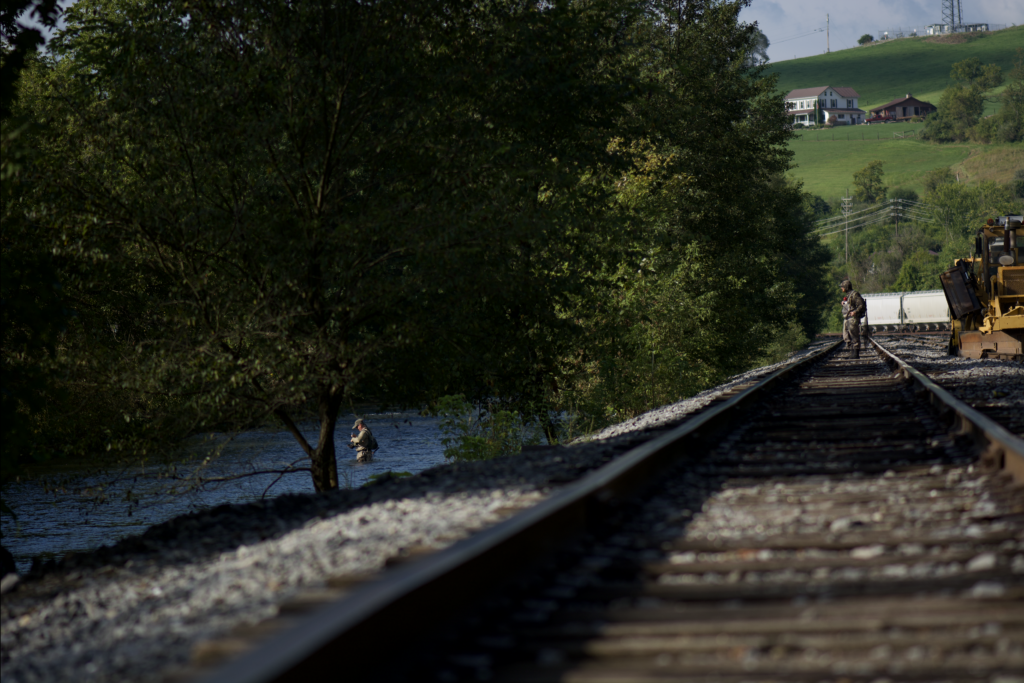 Anglers fishing Spring Creek by the train tracks