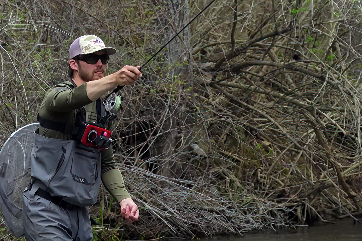 An angler doing the euro nymphing technique known as the pitch cast